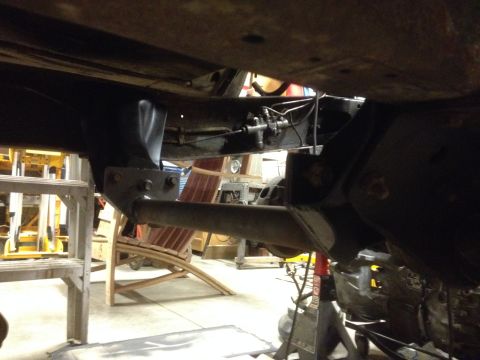 1978 Ford Bronco - The underside of a vehicle is shown, focusing on the frame and suspension parts.