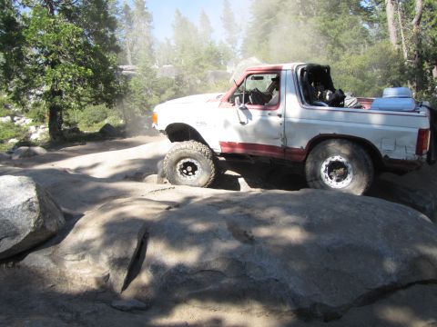 1984 Ford Bronco - This 1980s Ford Bronco navigates a rocky trail, kicking up dust.