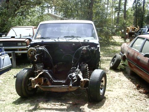 1985 Ford Bronco - This truck chassis lacks an engine and is missing its front clip, making identification difficult.