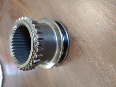 1995 Ford Bronco - Close-up of a metal gear part with splines and decorative etching.