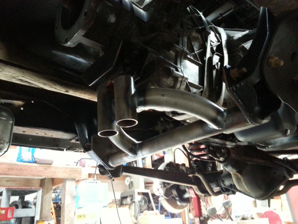 Underside view of a vehicle with a custom dual exhaust system installed.