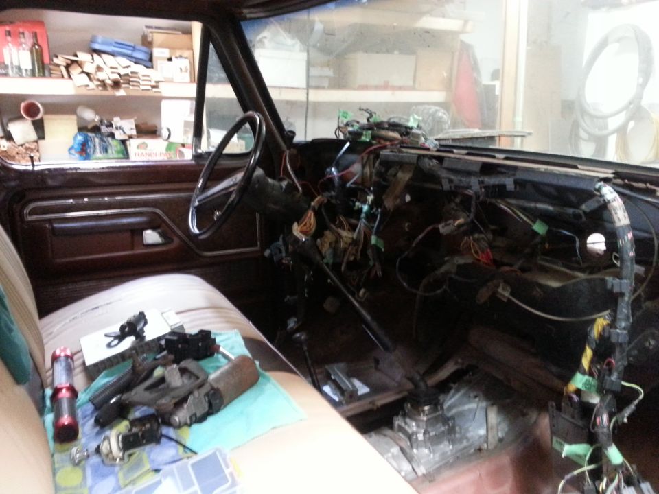 Stripped truck interior with dash apart and disassembled steering column