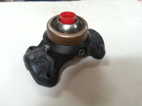 1978 Ford Bronco - A black Spicer bearing assembly with a red cap is shown mounted on a white surface. The bearing assembly has two mounting holes and text th…