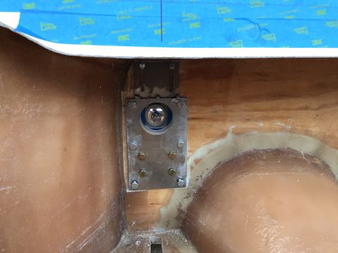 1923 Ford Model T - A close-up view shows a metal bracket with a silver circular mechanism attached to a wooden surface. Blue tape with "3M" and "Lock" brandin…