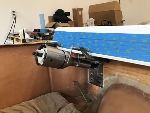 1923 Ford Model T - A close-up view shows a steering column assembly being installed inside a boat hull. The assembly is clamped in place and secured with a me…