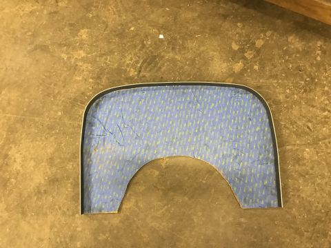 1923 Ford Model T - A custom-shaped piece of blue patterned material with a silver trim is laid on a concrete floor. The material has a U-shaped cutout on the…