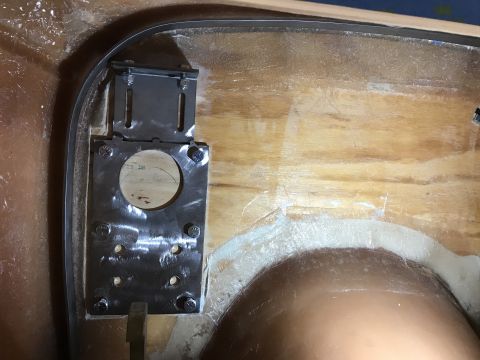 1923 Ford Model T - A metal bracket with a circular cutout is bolted to a wooden surface. The bracket appears to be part of a custom modification or installati…