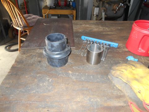 1992 Ford Bronco - A workbench displays a black rubber bellows, a metal cylinder, a set of wrenches on a blue holder, a red plastic container, and a pair of y…