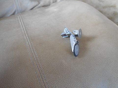 1992 Ford Bronco - A small, metallic object with wheels is resting on a textured, tan surface.