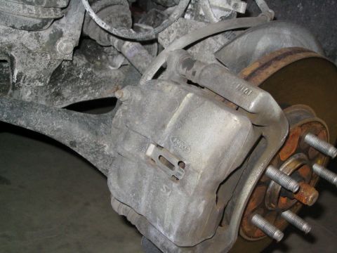 1996 Mercury Sable - Front brake caliper and rotor assembly with visible Ford branding.