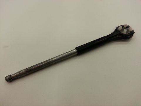 1978 Ford Bronco - A metal rod with a black plastic grip and a white plastic connector at the end is shown against a white background.