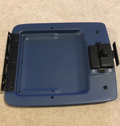 1995 Ford Bronco - A blue plastic lid with black hinges and a black latch mechanism is shown lying on a carpeted surface. The lid appears to be a part of a ve…