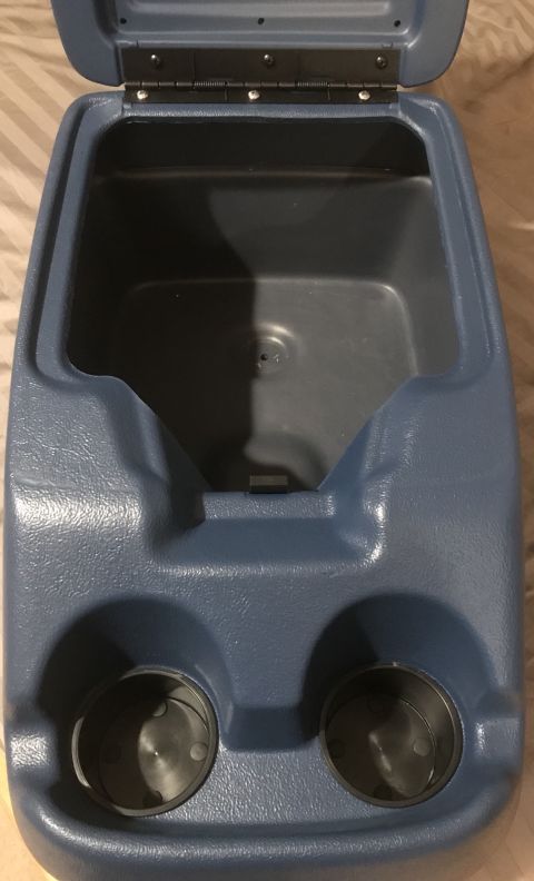 1995 Ford Bronco - Overhead view of an open blue plastic center console with two cup holders on the bottom and a storage compartment inside. The console is hi…