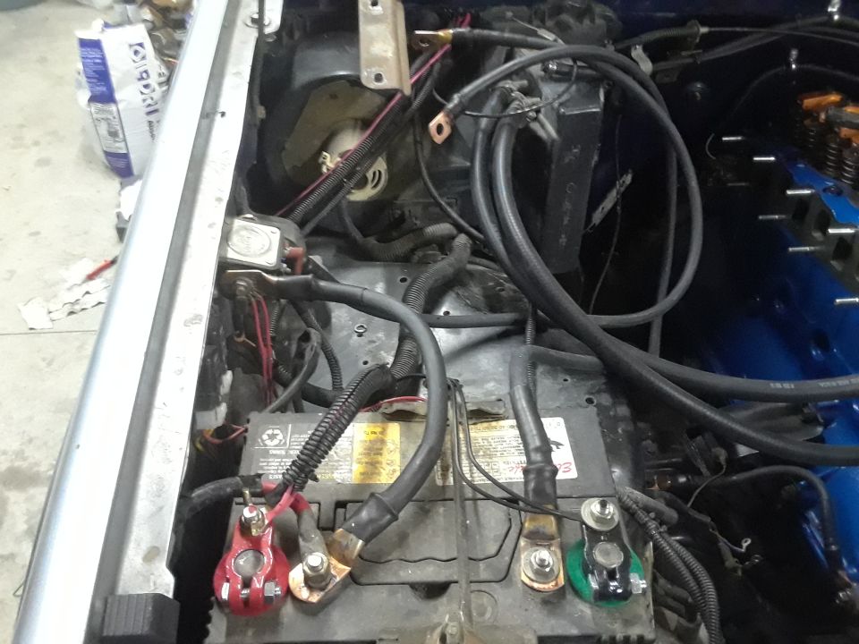 Vehicle engine bay with car battery and wiring
