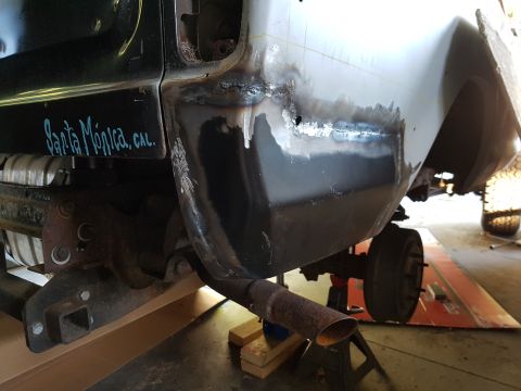 1978 Ford Bronco - A close-up view of the rear quarter panel of a vehicle undergoing repair, showing fresh welds and primer. Text reading "Santa Monica, CAL."…