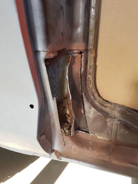 1978 Ford Bronco - This image shows severe rust and damage to the lower door jamb area of a vehicle, likely a classic SUV or truck. The metal is corroded and…