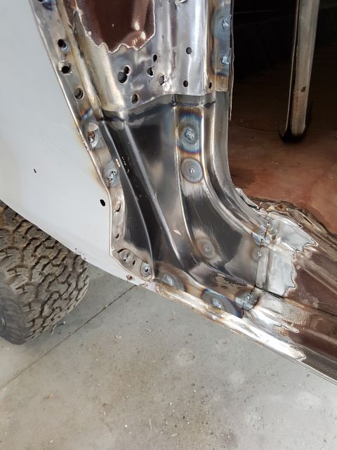 1978 Ford Bronco - This image shows the interior of a vehicle's rocker panel area that has undergone significant metal repair and welding. The bare metal show…