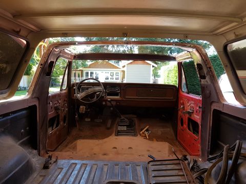 1978 Ford Bronco - Interior view of a classic Ford Bronco undergoing restoration. The dashboard, steering wheel, and door panels are visible, with the interio…