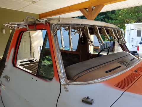 1978 Ford Bronco - A vintage pickup truck, possibly a 1978 Ford Bronco, is undergoing restoration. The roofline is being worked on, with numerous locking plie…