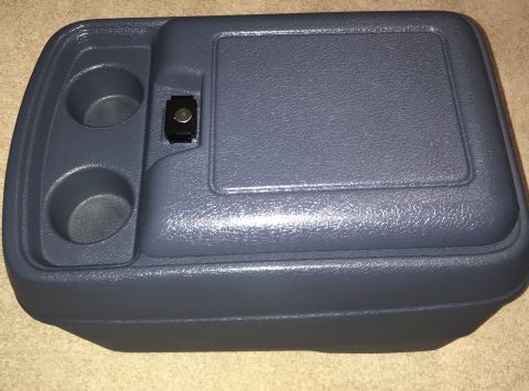 1995 Ford Bronco - A dark blue plastic center console organizer with two cup holders and a latching compartment is shown from a slightly elevated angle.
