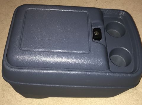 1995 Ford Bronco - A dark gray plastic center console with two cup holders and a small locking compartment is shown from a slightly elevated angle.