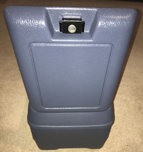 1995 Ford Bronco - A blue plastic armrest console with a black lock mechanism is shown in this close-up, angled shot.