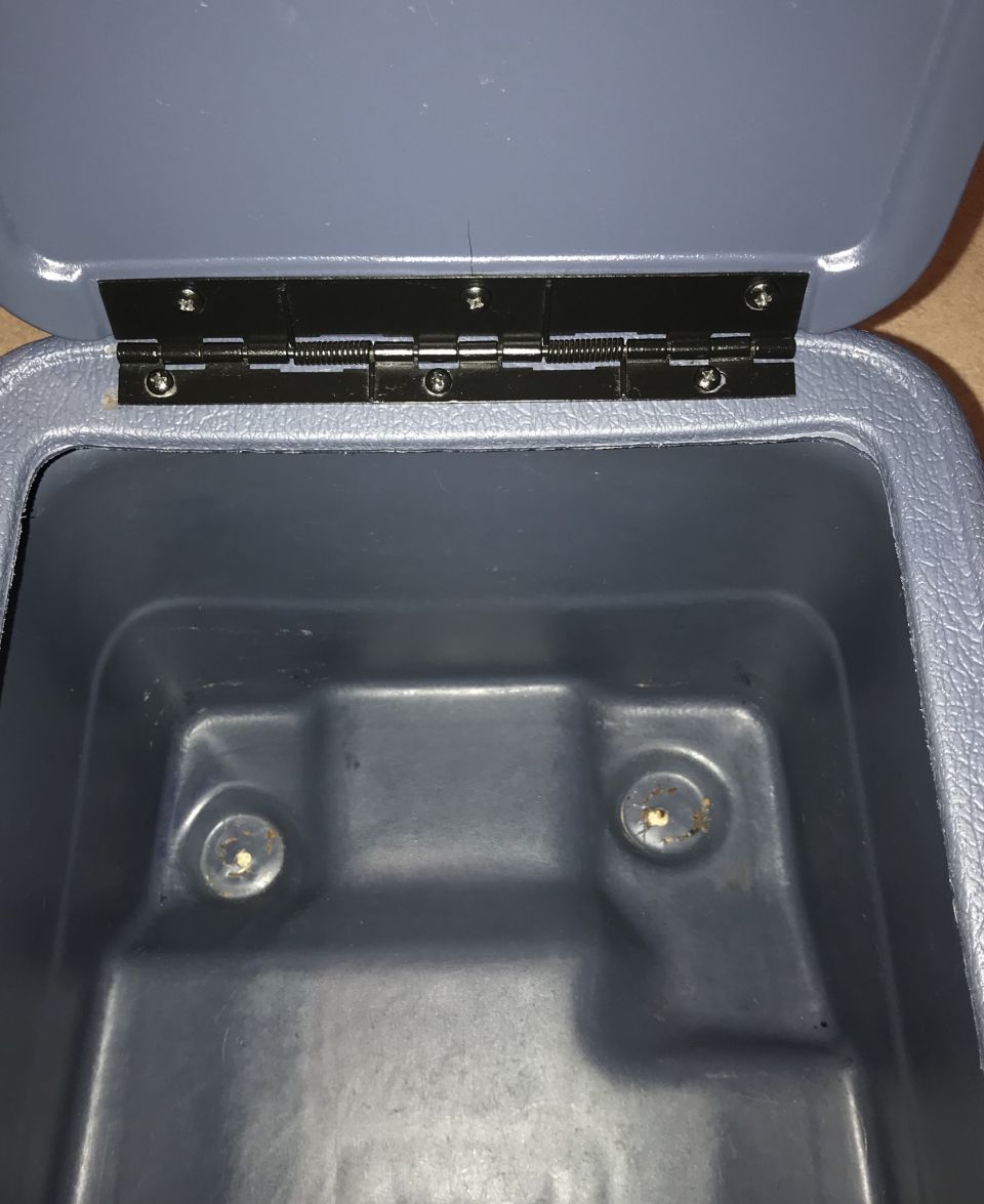 Open grey plastic storage bin with black hinge and interior indentations.