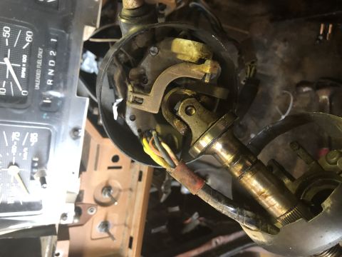 1980 Ford Bronco - This close-up image shows the steering column components of a vehicle, including a U-joint, wiring harness, and part of the instrument clus…