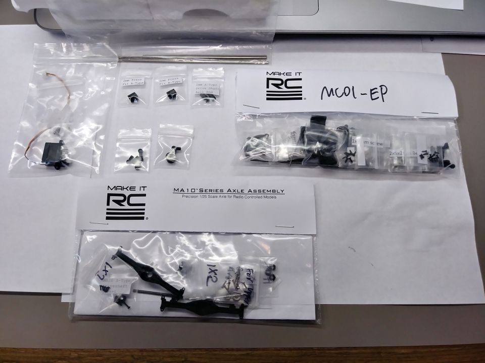 Here's a bit more of a scale axle assembly. And more bits like a smaller servo, drive shaft parts, suspension parts, etc.