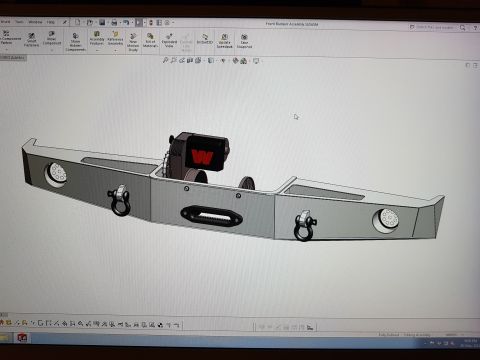 1978 Ford Bronco - A 3D CAD model of a custom front bumper assembly for a 1978 Ford Bronco is displayed on a computer screen. The bumper features integrated w…