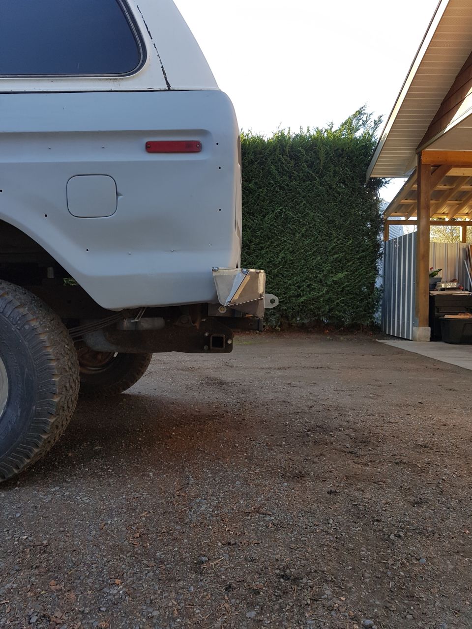 1978 Ford Bronco rear quarter panel, primer gray, with aftermarket bumper hitch