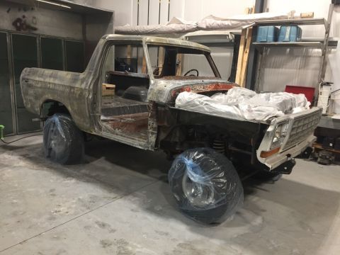 1978 Ford Bronco - This 1978 Ford Bronco is in a workshop, likely for bodywork or restoration.