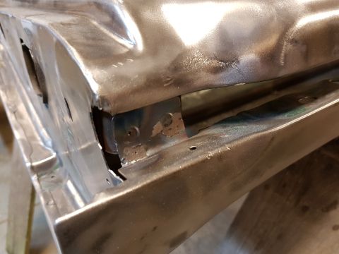 1978 Ford Bronco - Bare metal car door frame and hinge area showing rust and repair work.