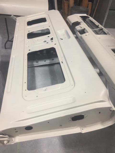 1978 Ford Bronco - Two white vehicle doors are shown in a workshop, likely undergoing restoration or preparation for painting.