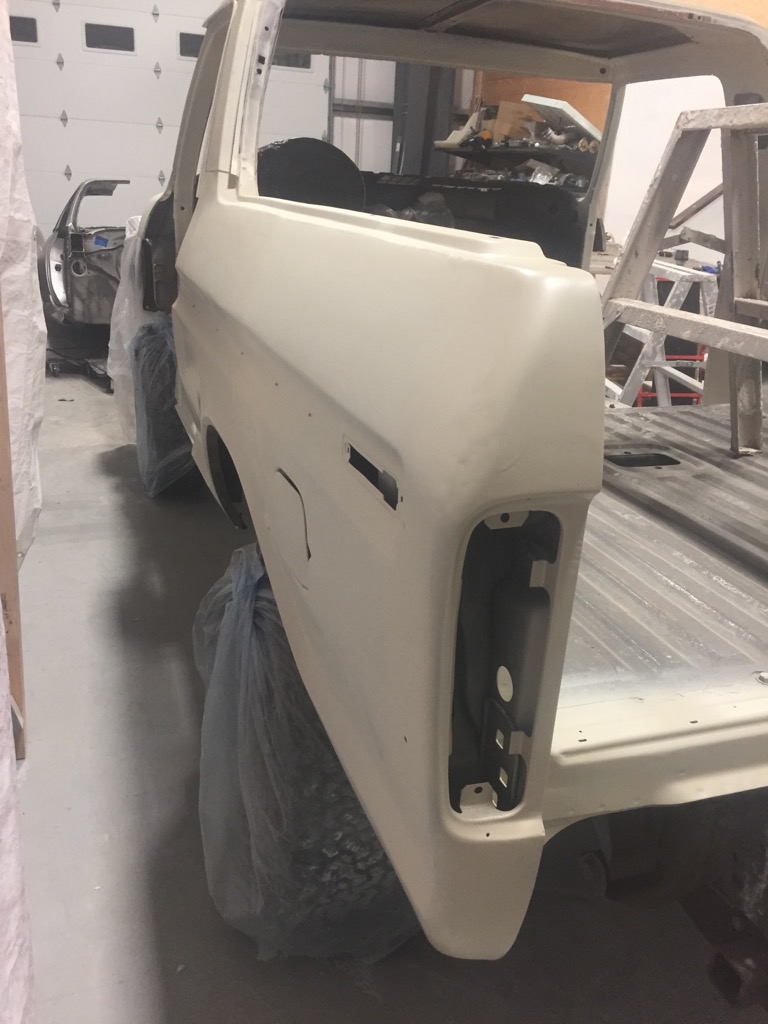 1978 Ford Bronco body in primer, rear quarter panel visible, another vehicle in background