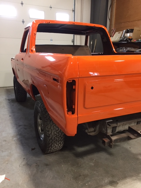 1978 Ford Bronco - Orange 1978 Ford Bronco body undergoing restoration in a garage.