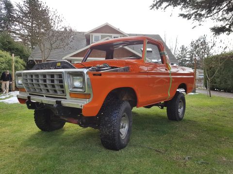 1978 Ford Bronco - This orange 1978 Ford Bronco is shown from a three-quarter front angle with its hood open.