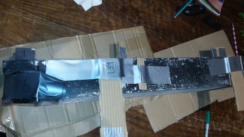 Car part labeled with numbered tape pieces: 1, 4, 5, 6