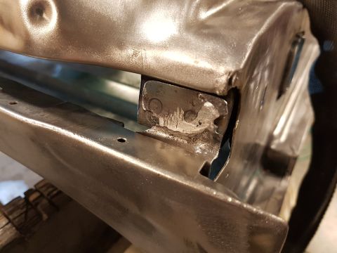1978 Ford Bronco - Close-up view of a metal bracket with visible rivets and some wear.
