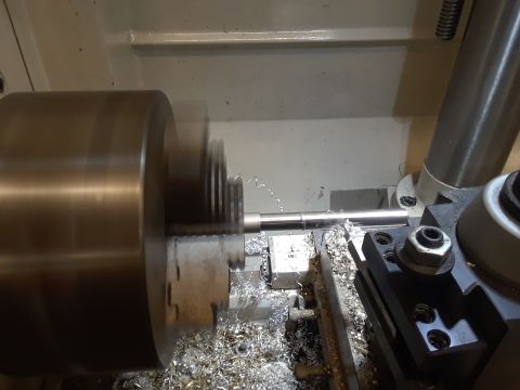 1985 Ford Bronco - Machining a metal rod on a lathe, creating threads and metal shavings.