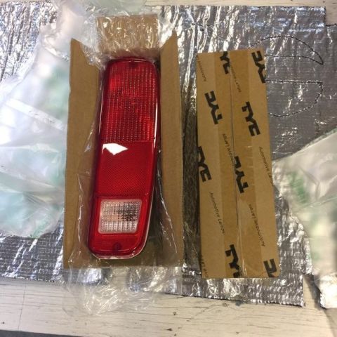 1978 Ford Bronco - A red taillight assembly is shown inside its packaging, alongside boxes labeled with the TYC brand.