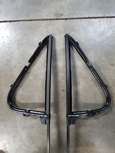 1978 Ford Bronco - Two triangular window frames are shown laid out on a concrete surface.