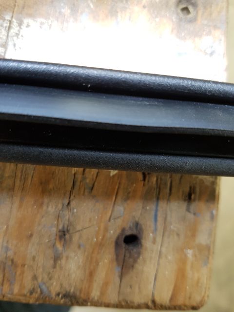 1978 Ford Bronco - A rubber seal is shown on a wooden surface, likely a workbench.