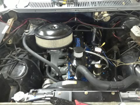 1985 Ford Bronco - Close-up view of a vehicle's engine bay, showing the engine and various components.