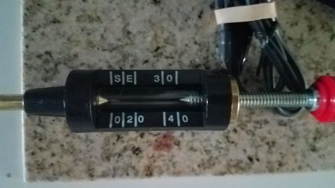 1985 Ford Bronco - A close-up view of a spark plug gap tool with numerical indicators.