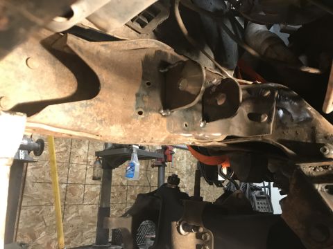 1984 Ford Bronco - Undercarriage view showing frame and suspension components, possibly during a repair or modification.