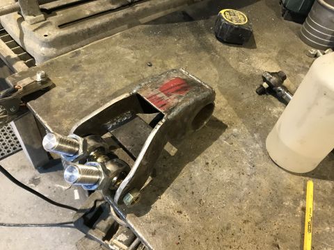 1984 Ford Bronco - Fabricated suspension part with threaded rod ends and bolts, likely for off-road use.