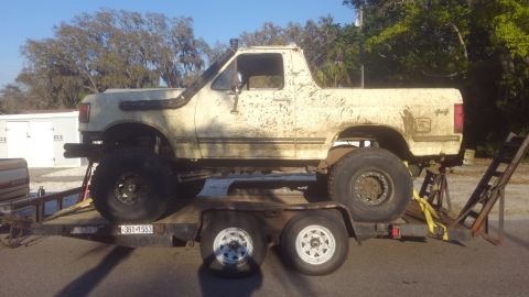 1988 Ford Bronco - Modified Ford Bronco on a trailer, likely prepared for off-road use.