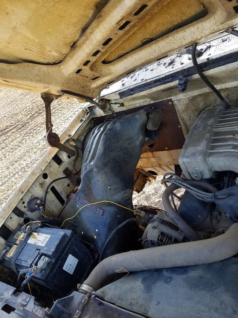 1988 Ford Bronco - The engine bay of a vehicle, showing various components under the hood.