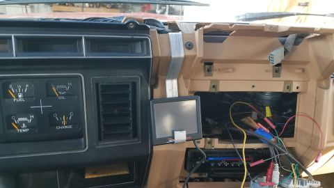 1985 Ford Bronco - Interior view of a 1985 Ford Bronco dashboard, showing gauges, air vents, and exposed wiring.